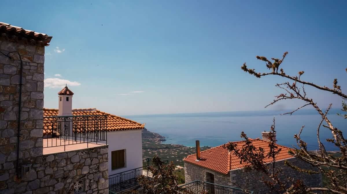 View from a Mani stone village over red rooftops to the sea